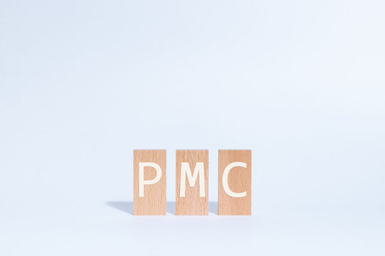 Eye-catching image of PMC text on wood blocks. The word stands for Private Military Company.