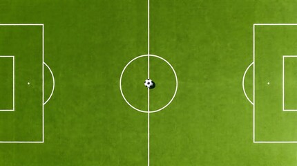 Naklejka premium Aerial view of a professional soccer field with a ball in the center circle, ready for a match on a bright day