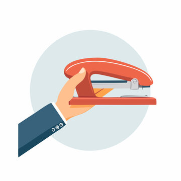 Hand holding a red stapler