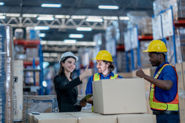 Fototapeta premium A logistics manager using a tablet to coordinate stock distribution parameters and verify cargo carton quantities with warehouse team operators.
