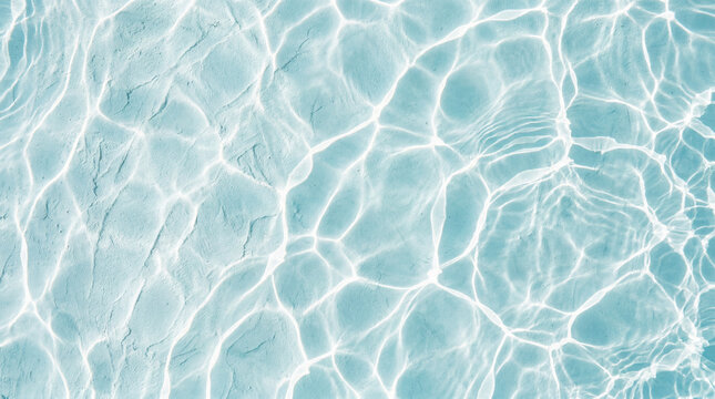 Crystal clear blue swimming pool water texture with bright white sun caustics and ripple patterns on the floor