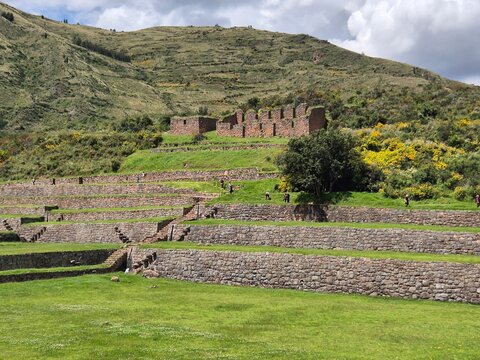 Ancient structure above an incan farming system with a mountain backdrop