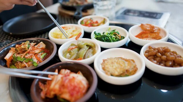 Assorted Korean Banchan Side Dishes Served in a Restaurant Setting