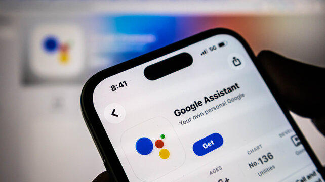 Closeup of a smartphone screen showing the google assistant app page on the apple app store, with the get button visible