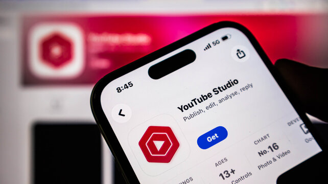 Closeup of a smartphone screen displaying the youtube studio app page in the apple app store, showing the app icon, download button, and details