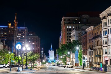 Fototapeta premium Night view down State Street in downtown Albany, New York, flanked by historic architecture and streetlights, United States