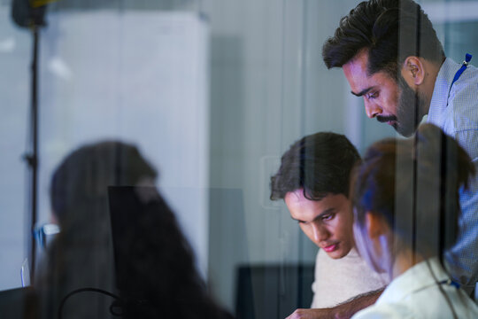 An agile product manager presenting software development workflows and data pipeline models on a whiteboard to her startup engineering team.