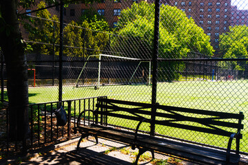 A serene soccer field behind a chain link fence with a goal post and green grass.  © kareem