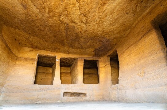 Detailed view of the interior chambers and carved alcoves within a historic Nabataean rock cut tomb at the Hegra UNESCO World Heritage site in Al Ula, Saudi Arabia.