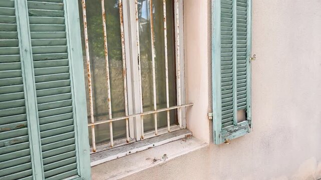 Weathered Pastel Green Window Shutters on Rustic French Architecture