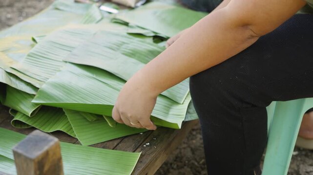 Preparing Banana Leaves for Wrapping Cassava Suman with Coconut Leaf Strips