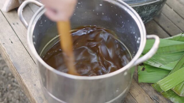 Mixing Brown Sugar and Coconut Milk for Cassava Suman Preparation
