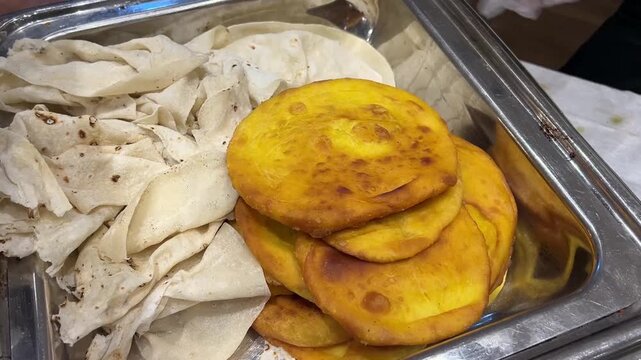 Flaky, golden-brown layered parathas and delicate handkerchief bread (rumali roti), showcasing classic Indian flatbread banquet menus for grand celebrations