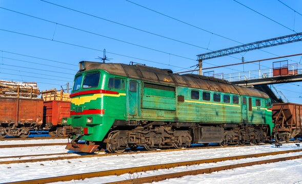 Diesel locomotive with a heavy freight train in winter in Korosten, Zhytomyr Oblast of Ukraine