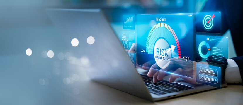 Risk management and business assessment concept. Businessman using laptop with glowing risk meter, data charts and tech icons for identifying, assessing, and mitigating future occurrences.