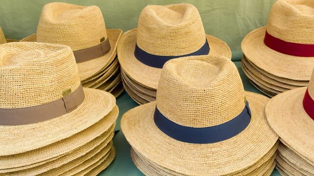 Stacks of Woven Straw Panama Hats at a French Market Stall
