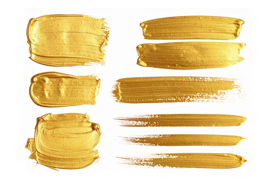 collection of gold paint brush strokes isolated on white background.