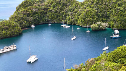 Naklejka premium Aerial View of Catamarans and Sailboats Anchored in a Tropical Palau Lagoon