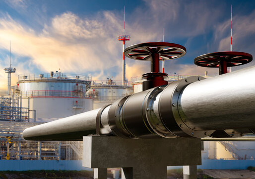 Oil pipeline valves and storage tanks at refinery for fuel transport and industrial processing.