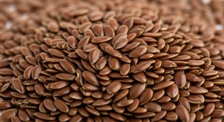 Obraz premium A detailed macro shot of glossy brown flax seeds piled together, showing the smooth texture and small teardrop shapes under soft lighting, detailed, superfood, nutrition