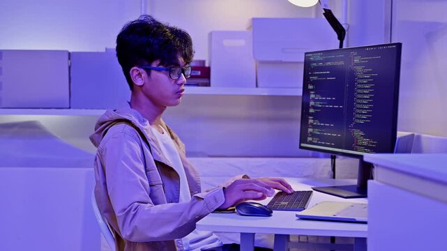 Focused Web Developer Analyze Digital Data On Desktop Computer At Night
