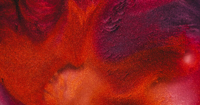 Blend paint. Glitter texture. Defocused pink purple orange colorful chemical droplet liquid leaking on abstract acrylic art background.