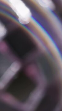Vertical video. Blur beam prism. Light swirling. Colorful arch ring flash in silver glass stroboscopic ball. Abstract spectrum twinkle art background.