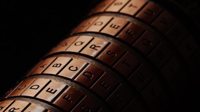 Slow macro pan revealing the word &ldquo;secret&rdquo; on a cryptex lock, evoking cryptography, mystery, and the unlocking of hidden information.on black background