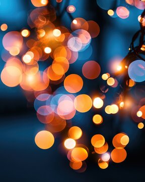 Warm orange and cool blue bokeh lights create a festive, dreamy atmosphere with soft, blurred circles against a dark background.