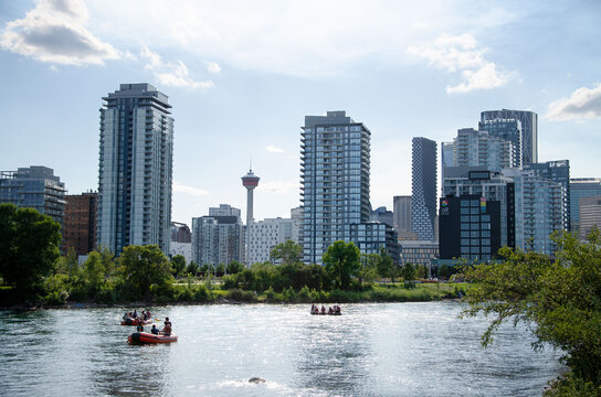Calgary downtown skyline with Calgary Tower and people rafting on Bow River, Alberta, Canada