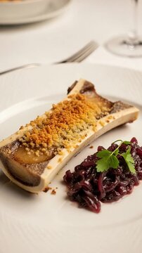 Roasted Bone Marrow with Red Onion Marmalade on a White Plate, Gourmet Appetizer Dish, Fine Dining Culinary Concept, Elegant Restaurant Food Photography