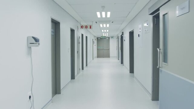 Empty hospital corridor interior with long clean hallway perspective, doors and soft lighting