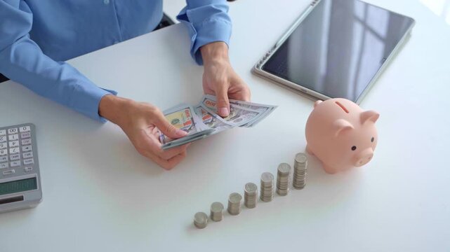 Asian businessman counting banknote with stacking coin and piggy bank on table investment concept.