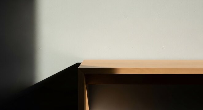 Minimalist abstract view of wooden shelf edge against wall.