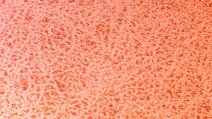A detailed macro shot showcases the soft, looped texture of a warm coral pink fabric, perfect for cozy garment design, furniture upholstery texturing, and creative presentation backgrounds. © Александр Серебрянни