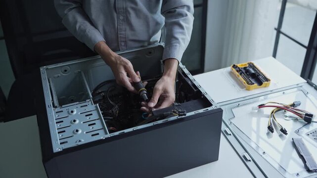 Asian IT engineer using screwdriver fix pc case