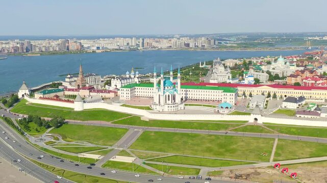 Kazan, Russia. The Kazan Kremlin, its white limestone walls and towers enclosing the Kul Sharif Mosque with blue domes and minarets, aerial panoramic view over the Kazanka River under clear summer sk