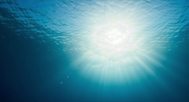 looking up from deep underwater toward surface with sharp golden sun rays beams perfect for summer