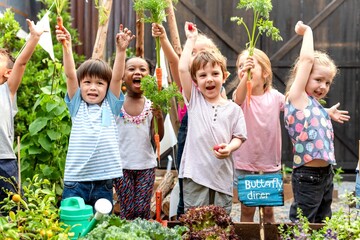 Joyful children gardening together outdoors.