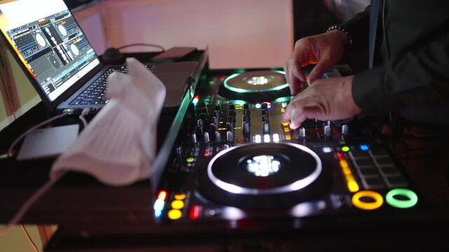 DJ Mixing Live On A Digital Controller during wedding reception In Club And Close-Up Hands