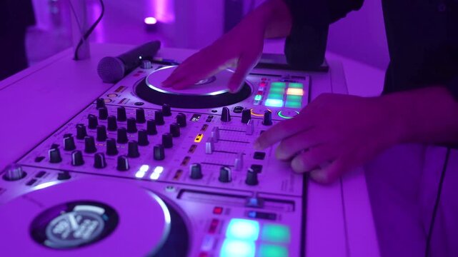 DJ Mixing Live On A Digital Controller during wedding reception In Club And Close-Up Hands