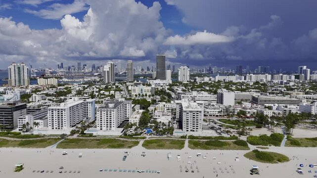Aerial skyline of Miami Beach, Florida at sunset with bay, highrise buildings and dramatic clouds. g.