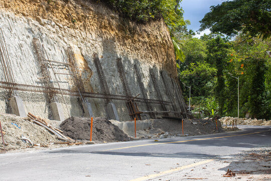 Retaining Wall Construction Site Along a Tropical Road with Steel Reinforcement Bars and Concrete Foundation, Infrastructure Development in the Philippines, Bohol