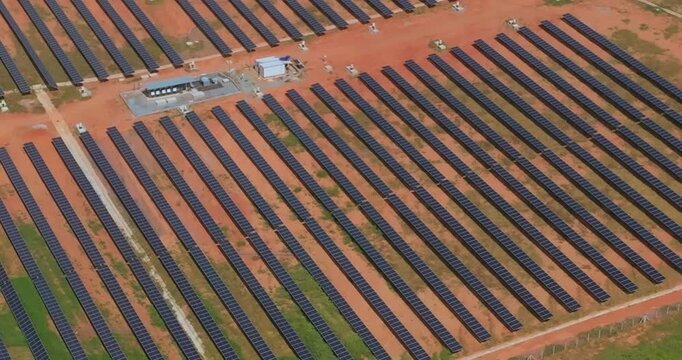 Oblique aerial view of photovoltaic panel rows in Santo Ant&ocirc;nio do Monte, Minas Gerais, Southeast Brazil, documenting utility scale solar infrastructure and electricity production, slow orbit shot