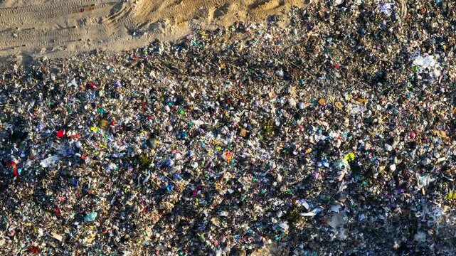 The landfill site shows large amounts of garbage and plastic contamination. Conditions include unsanitary waste disposal. Risks of disease outbreaks and rodent-borne viruses exist.