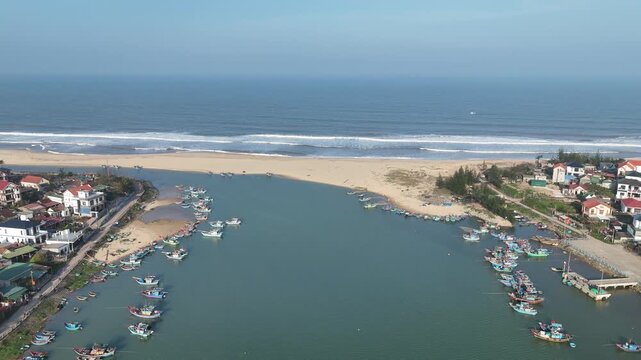 Nam Trach, Quang Binh (Quang Tri), Central Vietnam &ndash; 4K aerial drone footage of river mouth, East Sea, sandy beach, fishing village, boats, beachfront roads and seaside landscape near Dong Hoi City