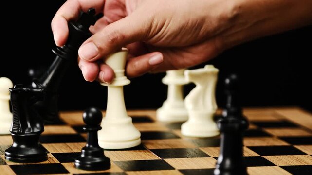 The hands of man on the competition and the strategic planning guidelines on the checkmate board. Succeed