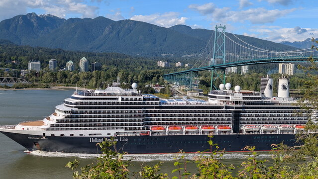 Luxury Holland America Line Cruise Ship Nieuw Amsterdam Passing Under Lions Gate Bridge with Mountains in Background. Vancouver, BC, Canada. May 17, 2026.