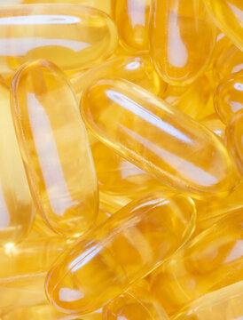 A bunch of golden omega-3 soft gel supplements for promoting health and wellbeing.