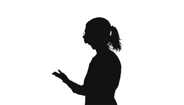Businesswoman stands in profile with one arm extended to explain a concept or point out information, reflecting a professional engaged in active discussion during a corporate meeting or presentation.